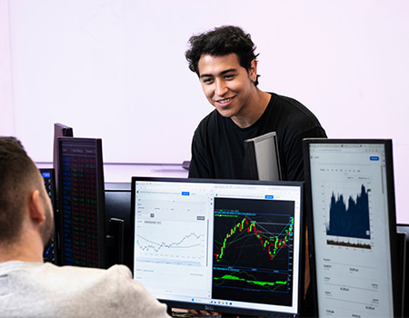 Man on a computer looking at graphs