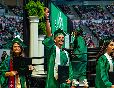 Student posing with UNT staff