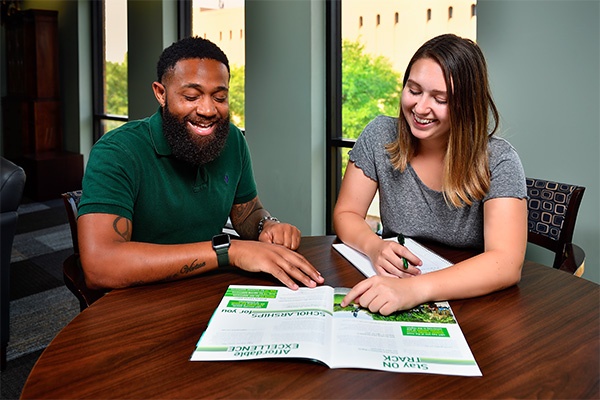 Students looking at a brochure