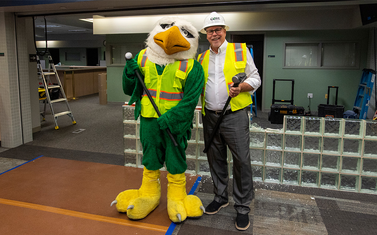President Smatresk puts a hardhat on Scrappy for safety